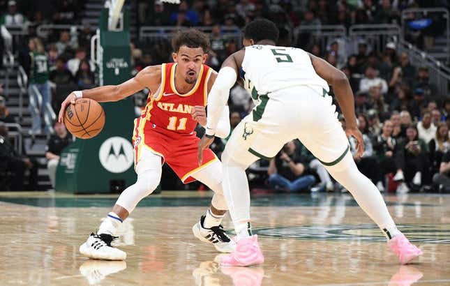 Oct 29, 2023; Milwaukee, Wisconsin, USA; Atlanta Hawks guard Trae Young (11) brings the ball up the court against Milwaukee Bucks guard Malik Beasley (5) in the second half at Fiserv Forum.