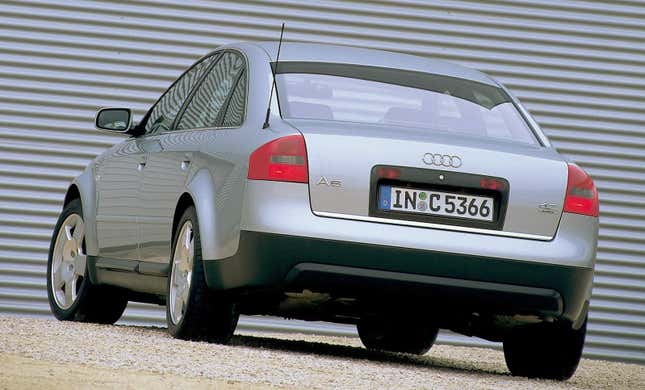 The rear 3/4 view of a silver Audi A6 showing off its blistered fender flares and minimalist rear styling