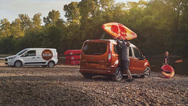 A photo of two Ford Transit Connect vans near a river. 