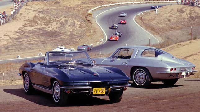 A photo of two Corvette cars parked near a race track. 