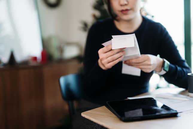 Woman reading receipts