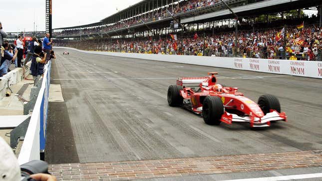 Michael Schumacher takes the checkered flag at the controversial 2005 U.S. Grand Prix.