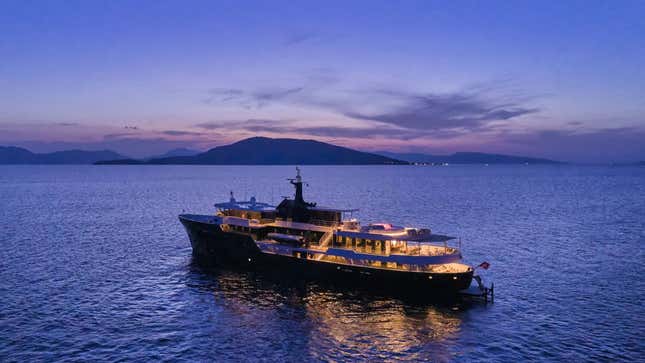 A photo of the Omnia yacht after the sun has gone down.