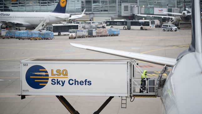 A photo of a truck loading food onto a plane. 