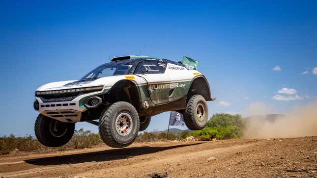 A photo of the Hummer Extreme E car jumping on track. 