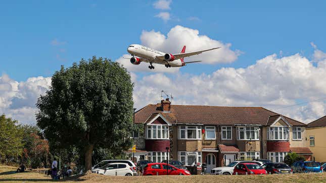 Virgin Atlantic Airways Boeing 787 Dreamliner as seen on final approach flying over the houses of Myrtle Avenue in London, a famous location for plane spotting, for landing at London Heathrow Airport LHR.