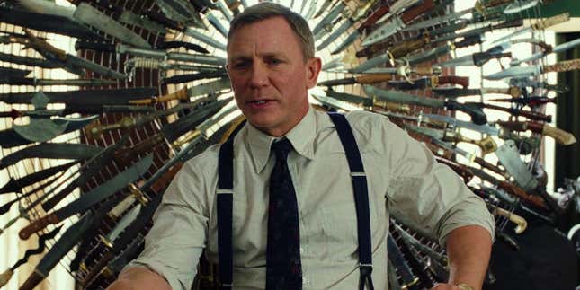 Daniel Craig as Benoit Blanc in 2019's Knives Out, with a multitude of knives in the background. 