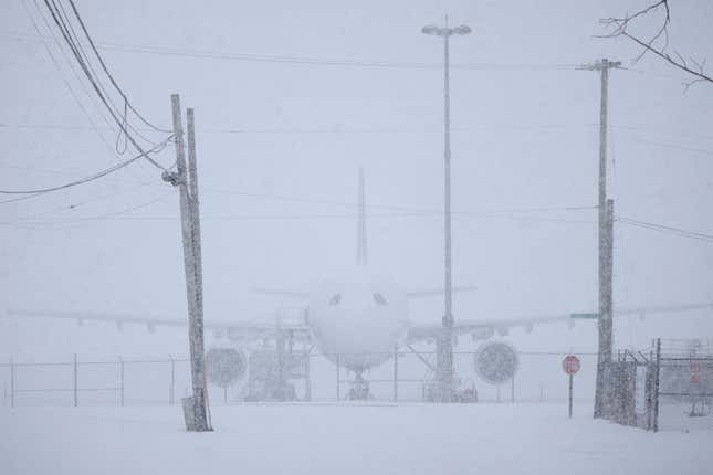 A plane covered in snow at Louisville Muhammad Ali International Airport 