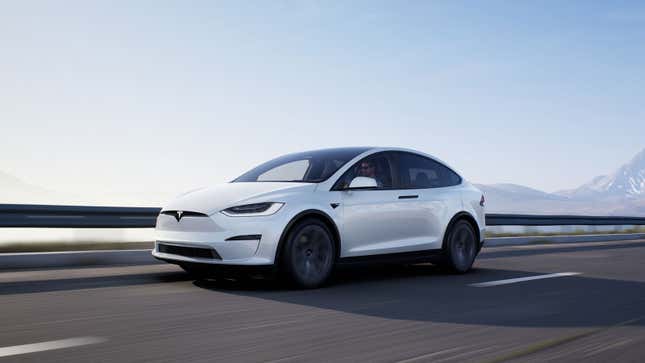 A photo of a white Tesla Model X Plaid. 