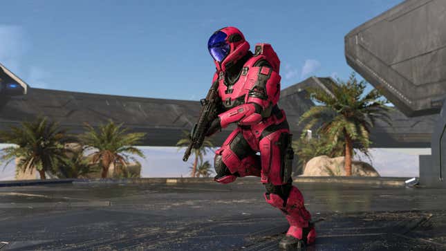 A red Spartan soldier runs across a forerunner construct on a bluebird day in Halo Infinite's multiplayer mode.