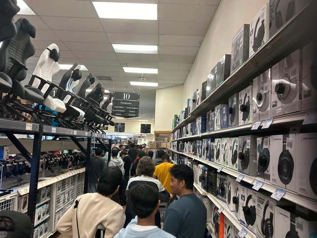 File - Patrons stand in a line that runs around the interior of the building on Black Friday, Nov, 24, 2023 at a Micro Center store in Yetta, Ga. On Tuesday, the Labor Department issues its report on inflation at the consumer level in November. (AP Photo/Mike Stewart, File)