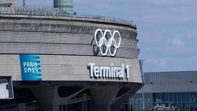 A plane takes off from Charles de Gaulle airport where the olympic rings were installed on terminal 1, in Roissy-en-France, north of Paris