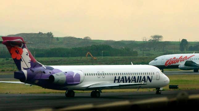 A Hawaiian Airlines plane and an Alaska Airlines plane