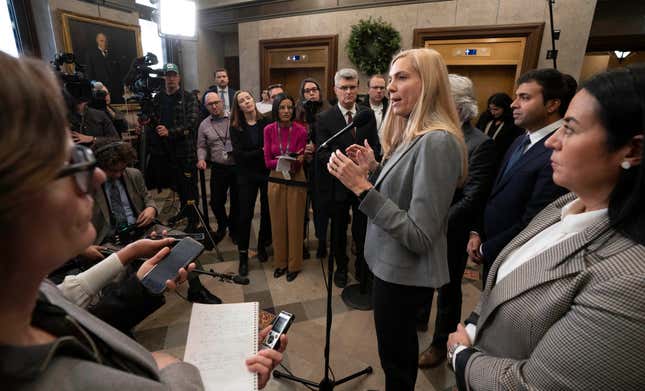 Members of Parliament and reporters listen as Canadian Heritage Minister Pascale St-Onge speaks about a deal with Google, Wednesday, Nov. 29, 2023, in the Foyer of the House of Commons in Ottawa, Ontario. Pascale St-Onge said that Google will contribute $100 million Canadian (US$74 million) — indexed to inflation — in financial support annually for a wide range of news businesses across the country. (Adrian Wyld/The Canadian Press via AP)