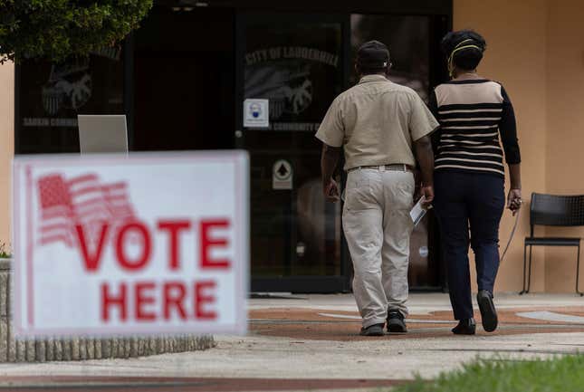 LAUDERHILL, FLORIDA - JANUARY 11: Voters arrive to cast their ballot at a polling station during the Congressional district 20 elections on January 11, 2022, in Lauderhill, Florida. 