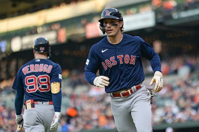 Boston Red Sox's Jarren Duran has his photo taken with a member of