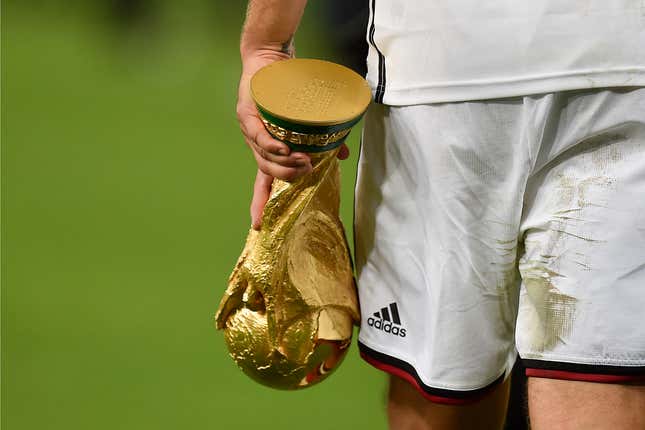 FILE - Germany&#39;s national player Lukas Podolski leaves the pitch with the World Cup trophy in his hand, wearing Adidas after winning the World Cup final soccer match in Rio de Janeiro, Brazil, Sunday, July 13, 2014. The German Football Association DFB announced today, that Nike will replace Adidas as the new supplier of the national teams from 2027. (AP Photo/Martin Meissner, File)