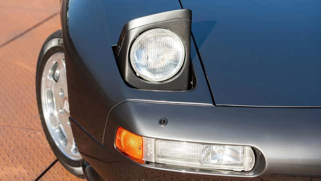 Close-up shot of a 1989 Porsche 928 GT Flachbau's headlight