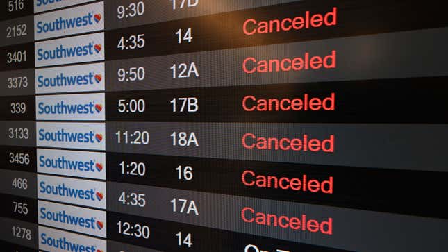 A photo of a departures board with six flights listed as canceled. 