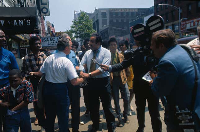 N.Y. Assemblyman Charles Rangel, coatless, wearing a light blue shirt, shown on the streets of Harlem accepting congratulations after having defeated U.S. Representative Adam Clayton Powell in the Democratic primary June 24th