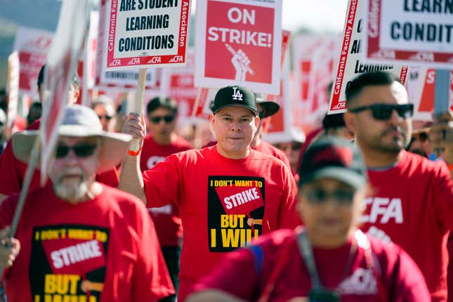 FILE - Members of the California Faculty Association rally and picket during a strike at California State Polytechnic University, Pomona, on Monday, Dec. 4, 2023, in Pomona, Calif. Faculty at California State University, the largest public university system in the U.S., could stage a systemwide strike later this month after school officials ended contract negotiations Tuesday, Jan. 9, 2024, with a unilateral offer of a 5% pay raise, far below what the union is demanding. (AP Photo/Ashley Landis, File)