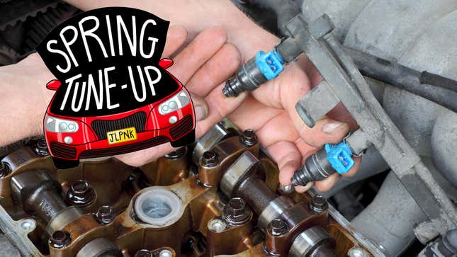 Car mechanic fixing fuel injector at two camshaft gasoline engine