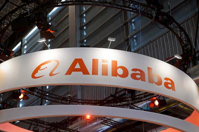 Alibaba logo displayed on a white banner hanging from a ceiling