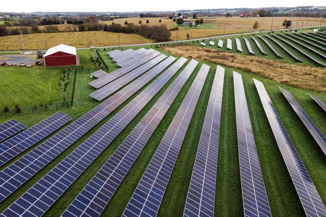 FILE - Farmland is seen with solar panels from Cypress Creek Renewables, Oct. 28, 2021, in Thurmont, Md. A new report says climate-altering pollution from greenhouse gases declined by nearly 2% in the United States in 2023, even as the economy expanded at a faster clip. The report from the Rhodium Group said the decline is a step in the right direction but far below the rate needed to meet President Joe Biden&#39;s pledge to cut U.S. emissions in half by 2030. (AP Photo/Julio Cortez, File)