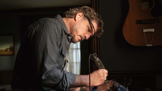 Joel works on a guitar.