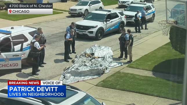 Chicago police officers standing around the deflated emergency evacuation slide