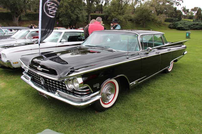 A 1959 Buick Invicta sedan in black looking immaculate on a lawn somewhere