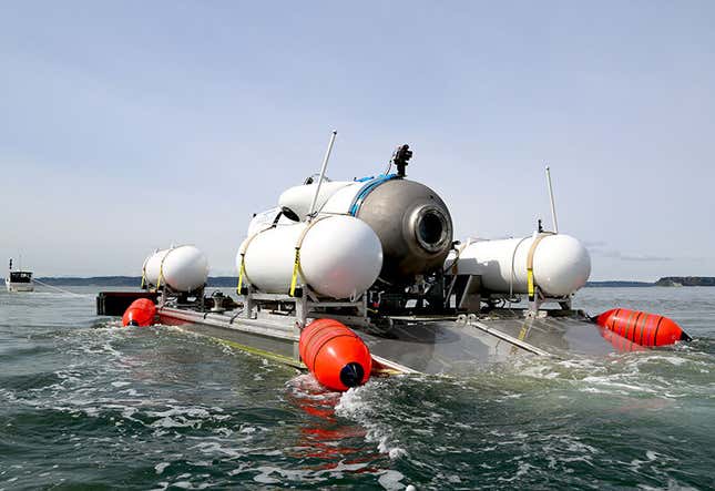 OceanGate submersible on a skiff floating on the surface of the ocean near the shore. 