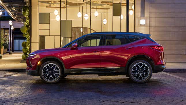 A photo of a red Chevrolet Blazer SUV parked up at night. 