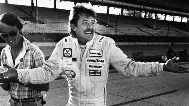 A black and white photo of racing driver Tim Richmond. 