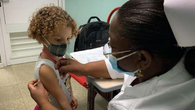A nurse prepares Roxana Montano, 3, to receive her dose of Soberana Plus, a Cuban vaccine against covid-19, on August 24, 2021 at Juan Manuel Marquez hospital in Havana, as part of the vaccine study in children.