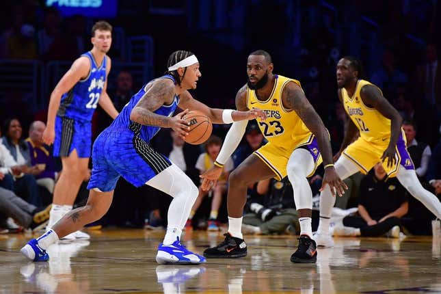 Oct 30, 2023; Los Angeles, California, USA; Orlando Magic forward Paolo Banchero (5) moves the all against Los Angeles Lakers forward LeBron James (23) during the second half at Crypto.com Arena.