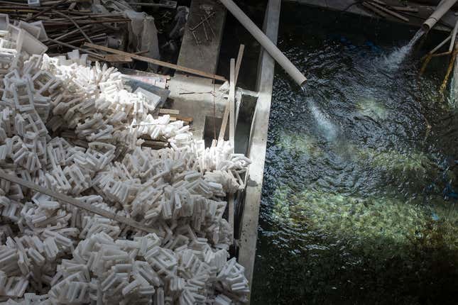 Packing materials for mining machines pile up beside the water-cooling system at a Bitcoin mine in Sichuan province.