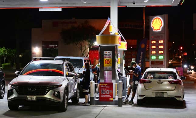 People pump gas into their vehicles at a Shell petrol station on October 2, 2023 in Alhambra, California.