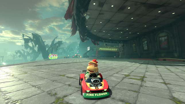 Bowser Jr. sits in a kart in front of a spooky theater.