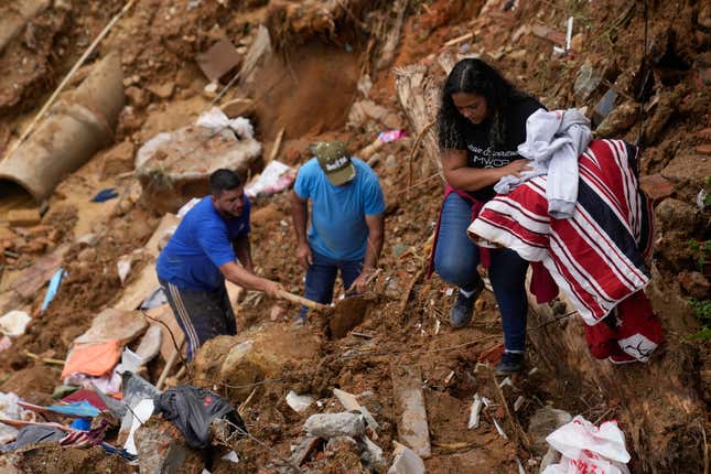 Priscilla Neves recovers belongings while waiting for news about her missing parents, who were in their family home when it was covered by mudslides.