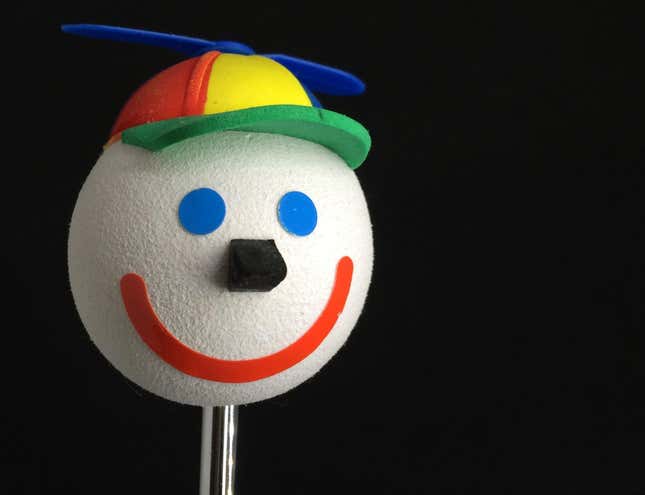 A 'Jack in the Box' smiling happy face car antenna ball topper with a spinning baseball cap