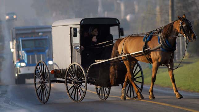 Amish children arrive via horse and buggy to their newly built schoolhouse April 2, 2007 in Nickel Mines, Pennsylvania.