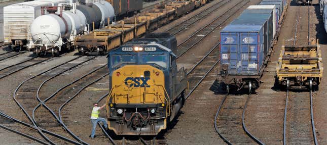 FILE - In this Thursday, July 12, 2012, photo, a rail yard worker climbs off a switching engine at the CSX facility in Boston. CSX Corp. reports earnings on Thursday, Oct. 19, 2023. (AP Photo/Charles Krupa, File)