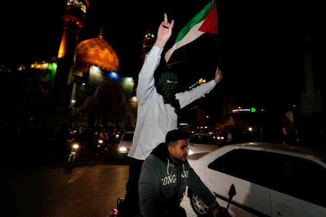 Iranian demonstrators wave a Palestinian flag during their anti-Israeli gathering at the Felestin (Palestine) Square in Tehran, Iran, early Sunday, April 14, 2024. Iran launched its first direct military attack against Israel Saturday. The Israeli military says Iran fired more than 100 bomb-carrying drones toward Israel. Hours later, Iran announced it had also launched much more destructive ballistic missiles. (AP Photo/Vahid Salemi)