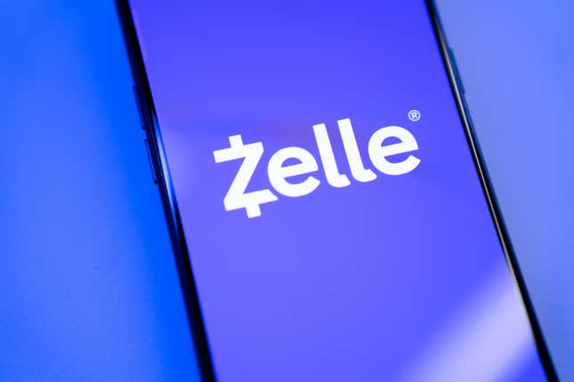 Close-up of a purple Zelle logo on a phone screen in front of a purple-blue background