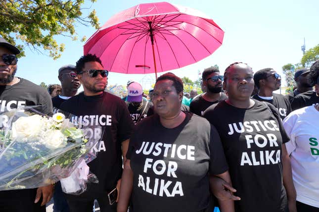 Charity Oriakhi, center, widow of Nigerian street vendor Alika Ogorchukwu, attends a demonstration to demand justice for her husband in Civitanova Marche, Italy, Saturday, Aug. 6, 2022.