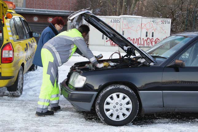 An ADAC (Allgemeiner Deutscher Automobil-Club e.V. - Germany's and Europe's largest automobile club) technical assistant helps a woman with her broken down car on January 6, 2009 in Berlin, Germany