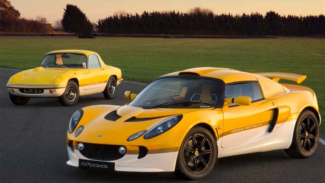 A photo of two yellow Lotus cars parked on a road. 