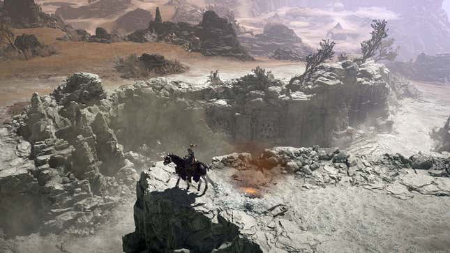 A person rides a horse in a wasteland.