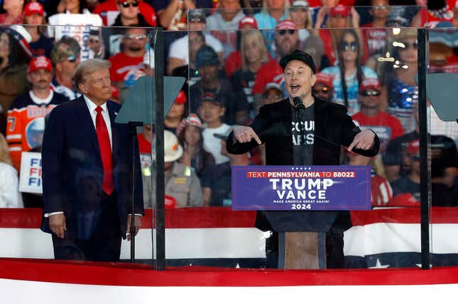 Elon Musk and President-elect Donald Trump on stage together with Musk at the microphone